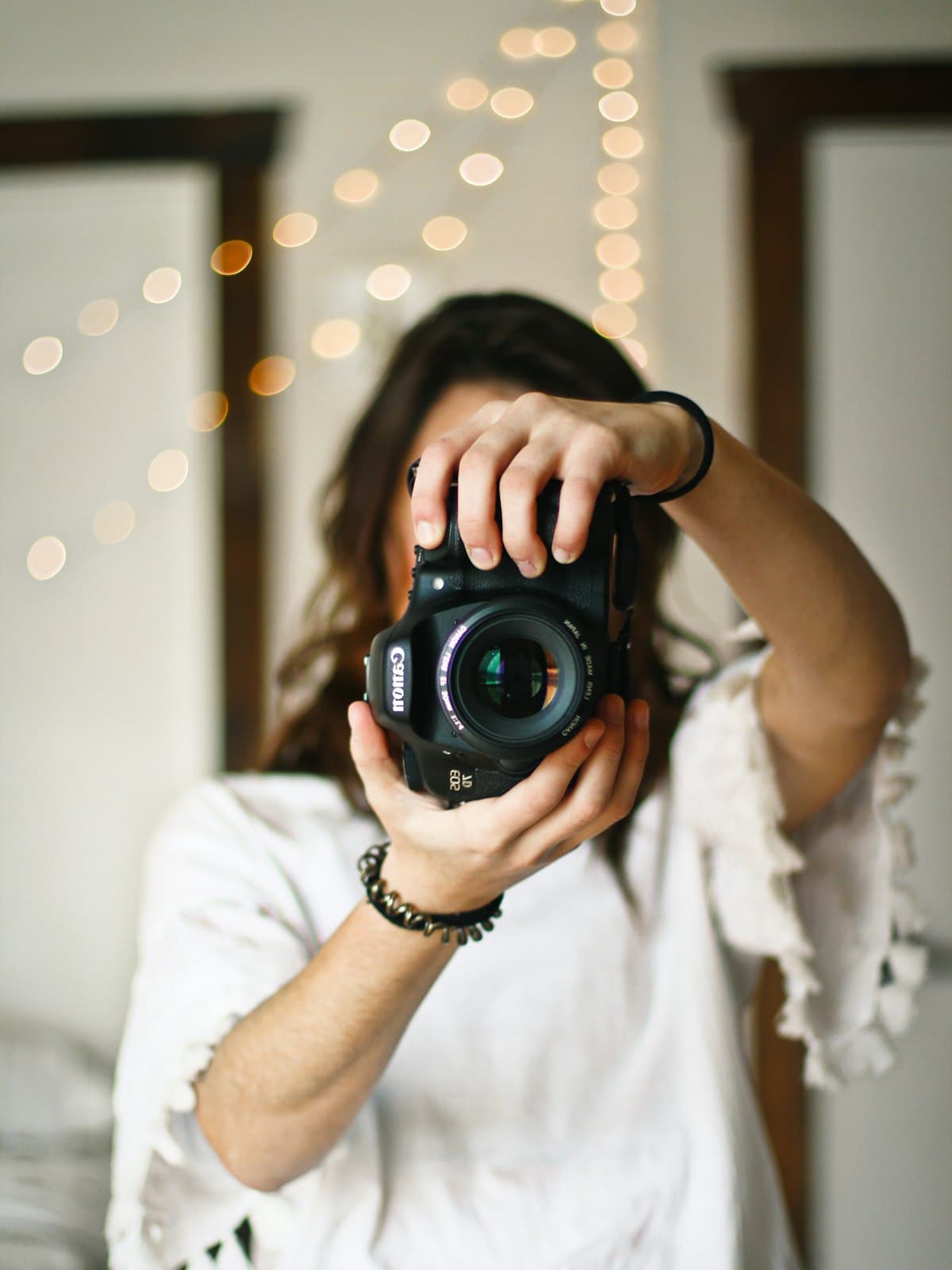 A photographer holding a camera at chest height