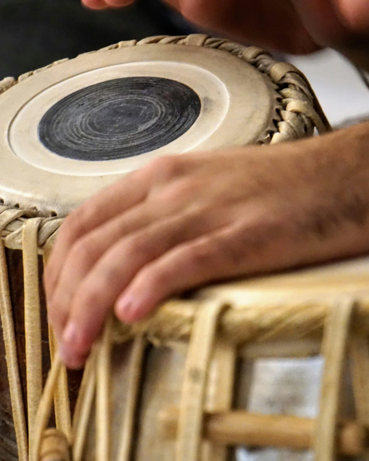 Fingers resting on the head of a tabla