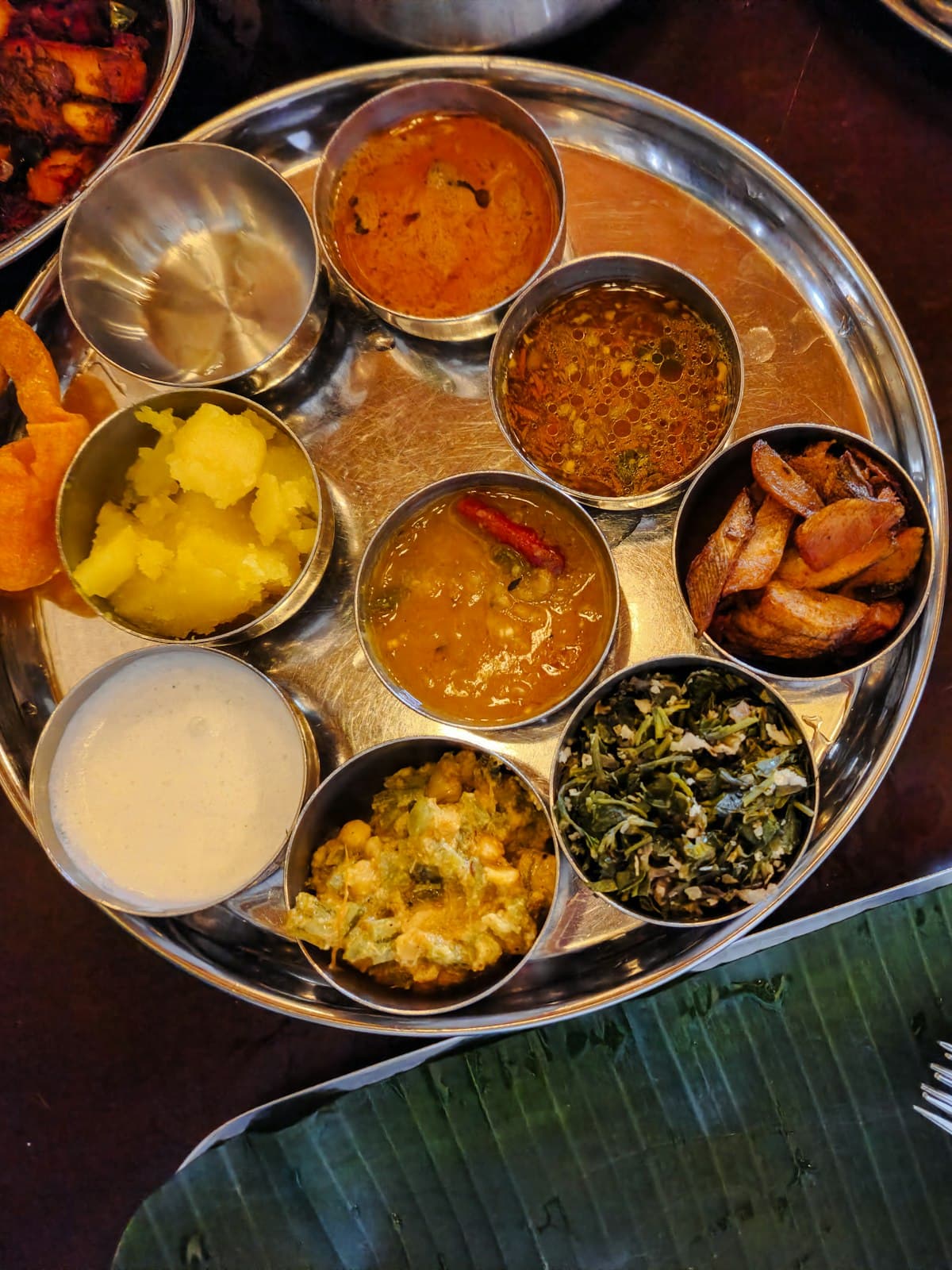 A thali laid out with rice, breads and small bowls